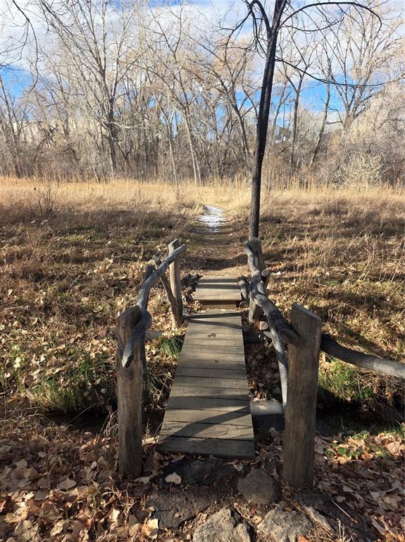 Image 35 of 37: Bridge over creek to walking trail