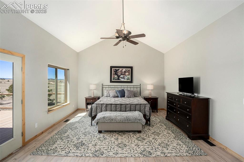 Image 14 of 47: Bedroom featuring access to exterior, light wood-style flooring, ceiling fa