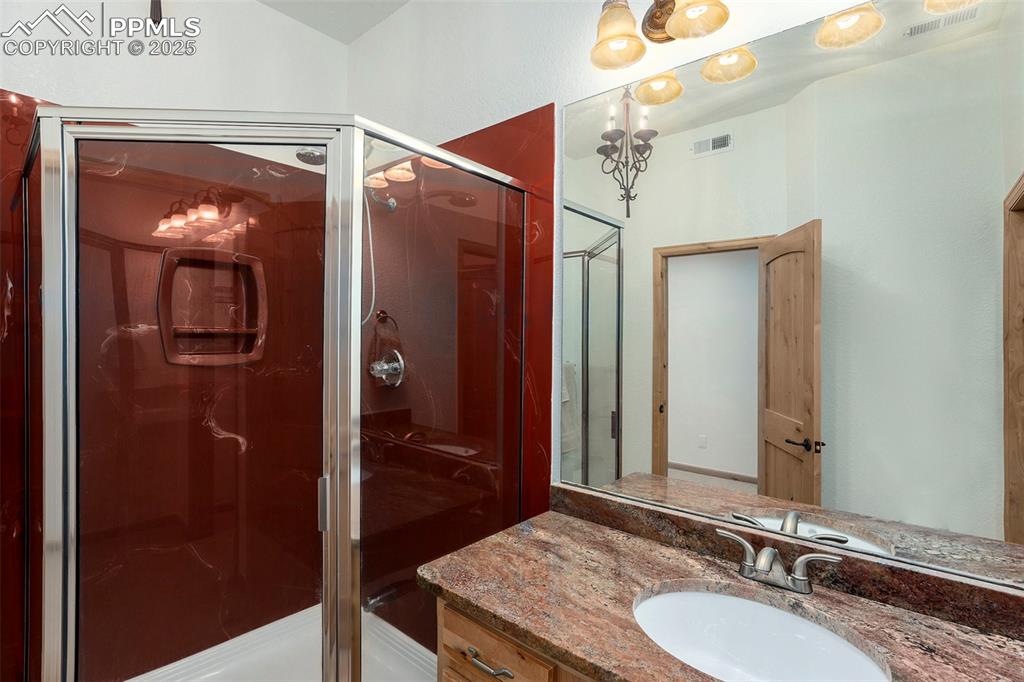 Image 24 of 47: Full bathroom featuring vanity and a stall shower