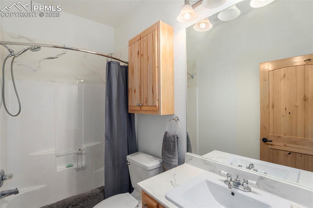 Image 29 of 47: Bathroom featuring vanity and shower / bathtub combination with curtain