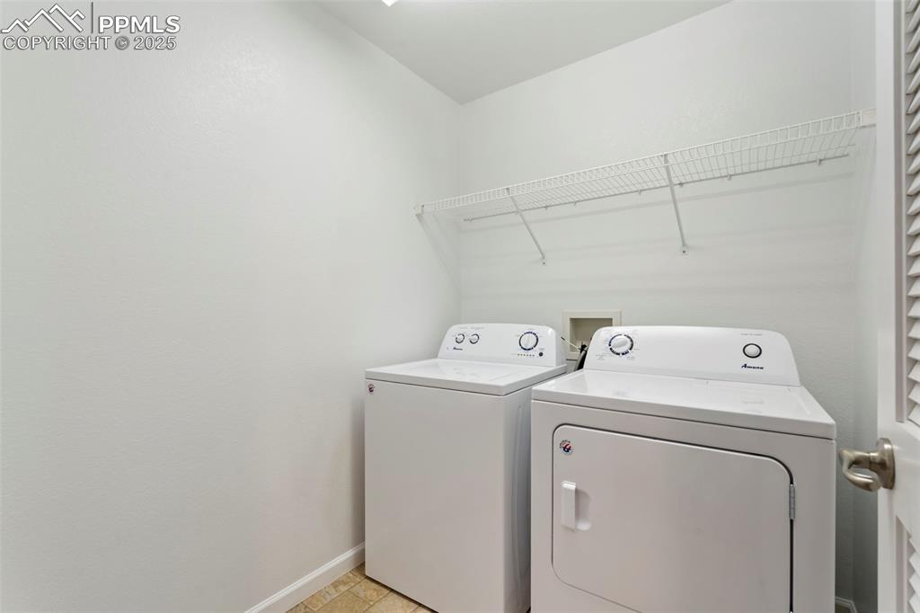Image 32 of 48: Laundry room with independent washer and dryer and baseboards