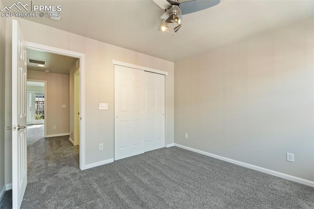 Image 34 of 48: Unfurnished bedroom featuring dark carpet and a closet