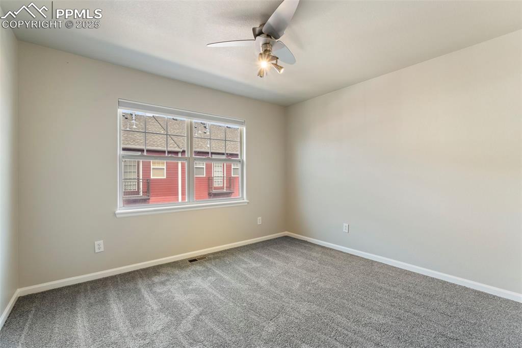 Image 35 of 48: Unfurnished room with ceiling fan and carpet flooring