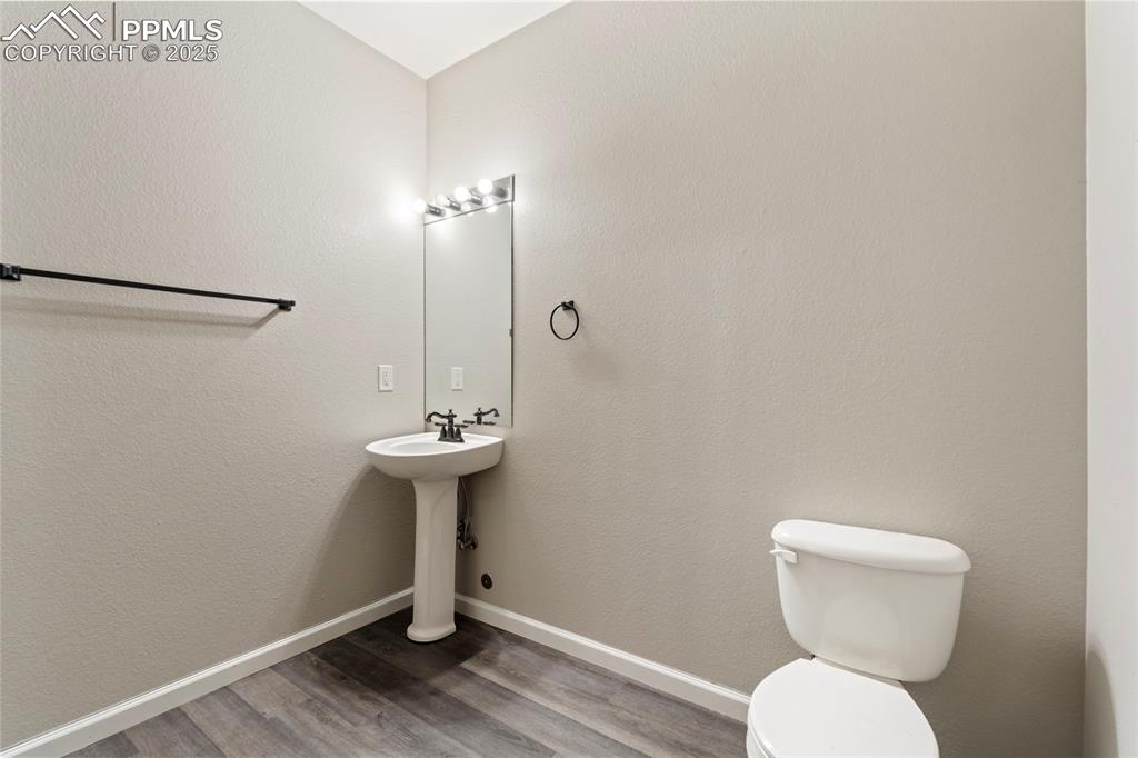 Image 42 of 48: Bathroom with toilet and wood finished floors