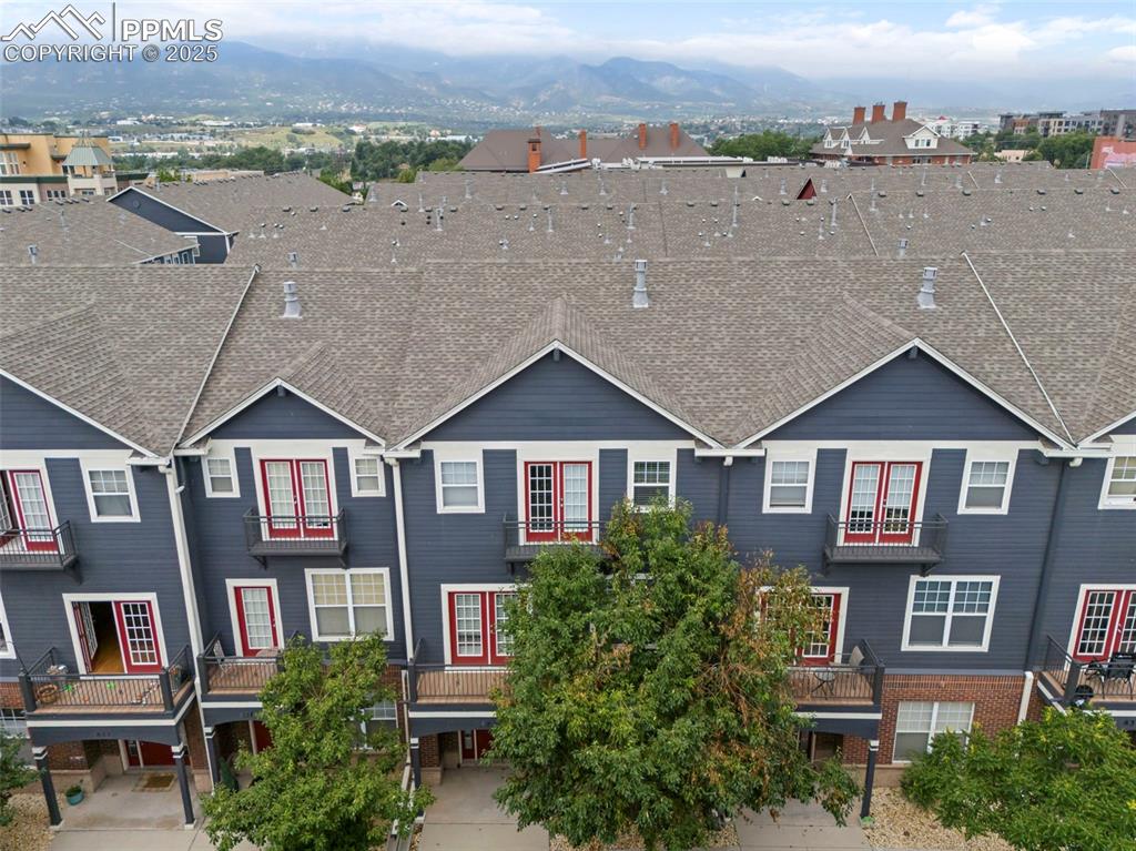 Image 44 of 48: Traditional home featuring a mountain view and roof with shingles