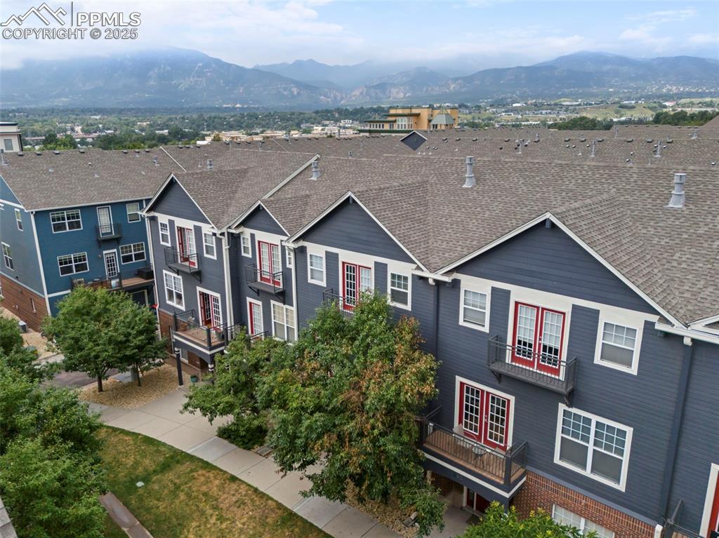 Image 45 of 48: Traditional-style house featuring a mountain view, a balcony, roof with shi