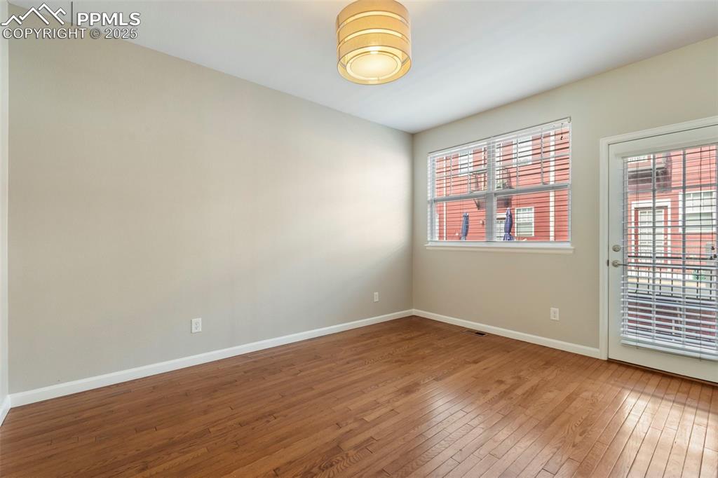 Image 7 of 48: Spare room featuring hardwood / wood-style flooring and baseboards