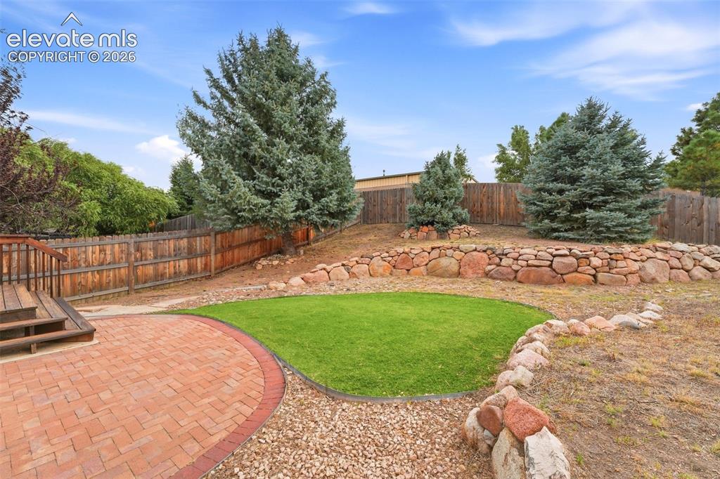 Image 16 of 47: Mature Blue Spruces and Flagstone Patio