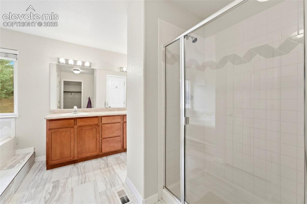 Image 22 of 47: Primary Bathroom Features Tile Flooring and Spacious Walk In Shower