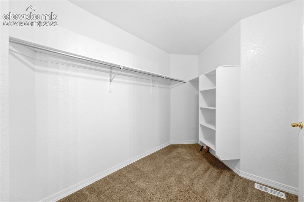 Image 23 of 47: Large Primary Walk In Closet with Built In Shelving