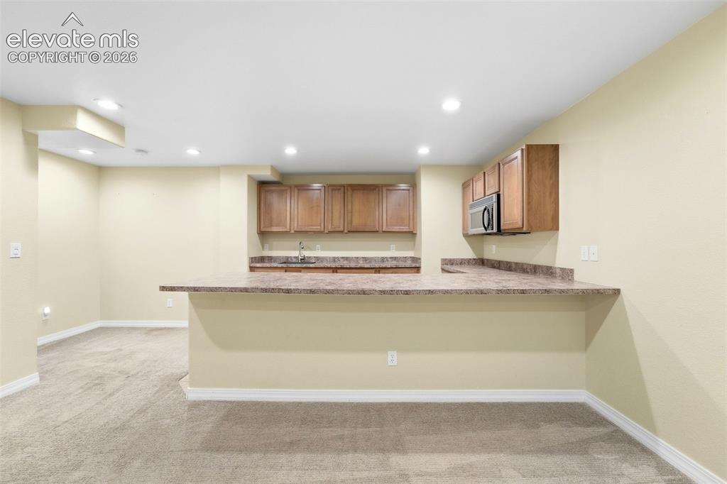 Image 33 of 47: View of Large Counter Bar at Kitchenette