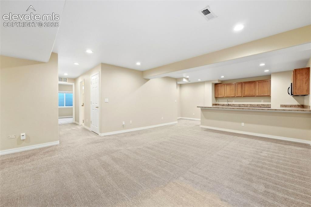 Image 34 of 47: Warm Recessed Lighting Throughout Basement Family Room