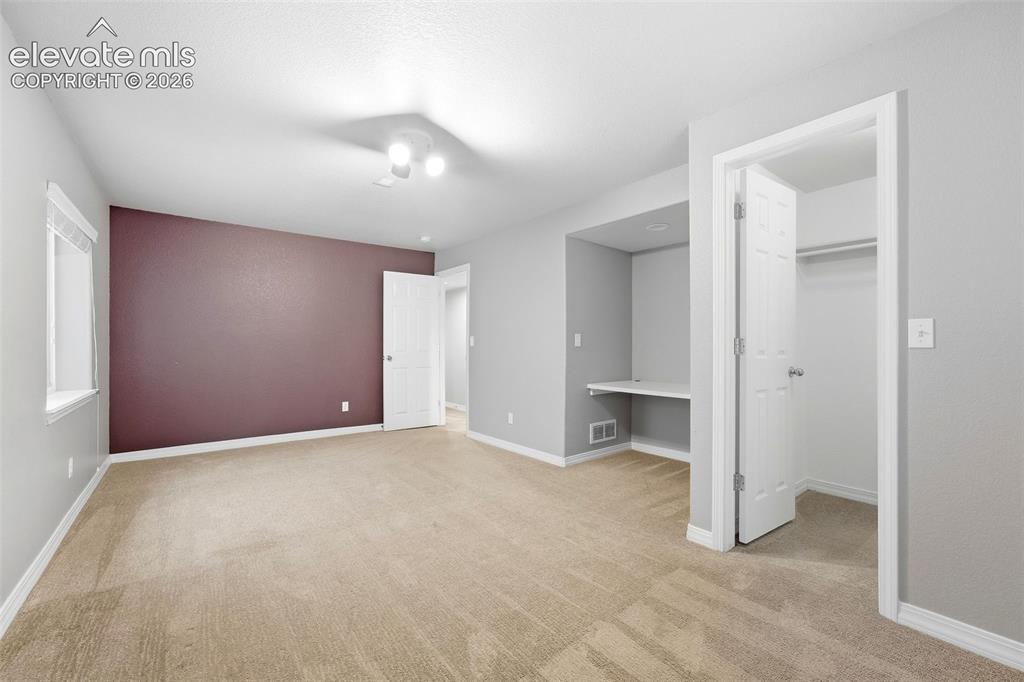 Image 36 of 47: Bedroom 3 in Basement with Built In Desk