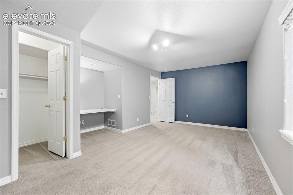 Image 38 of 47: Bedroom 4 in Basement with Built in Desk