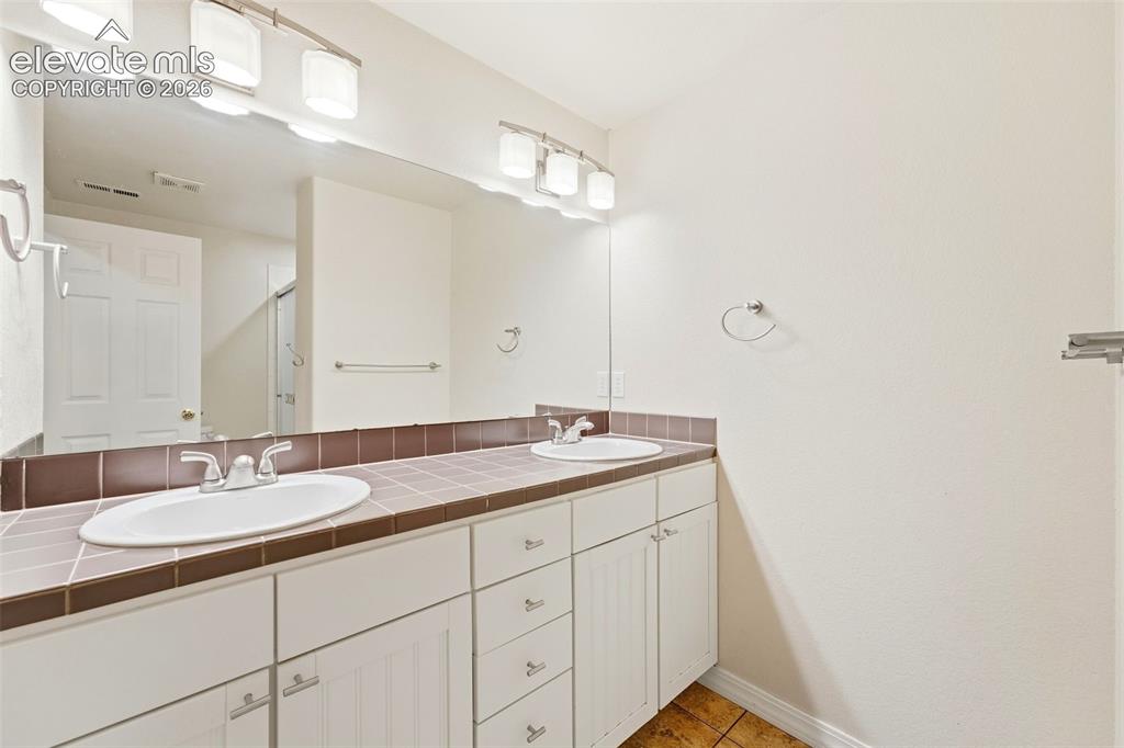 Image 40 of 47: Bathroom in Basement features Dual Vanity Space