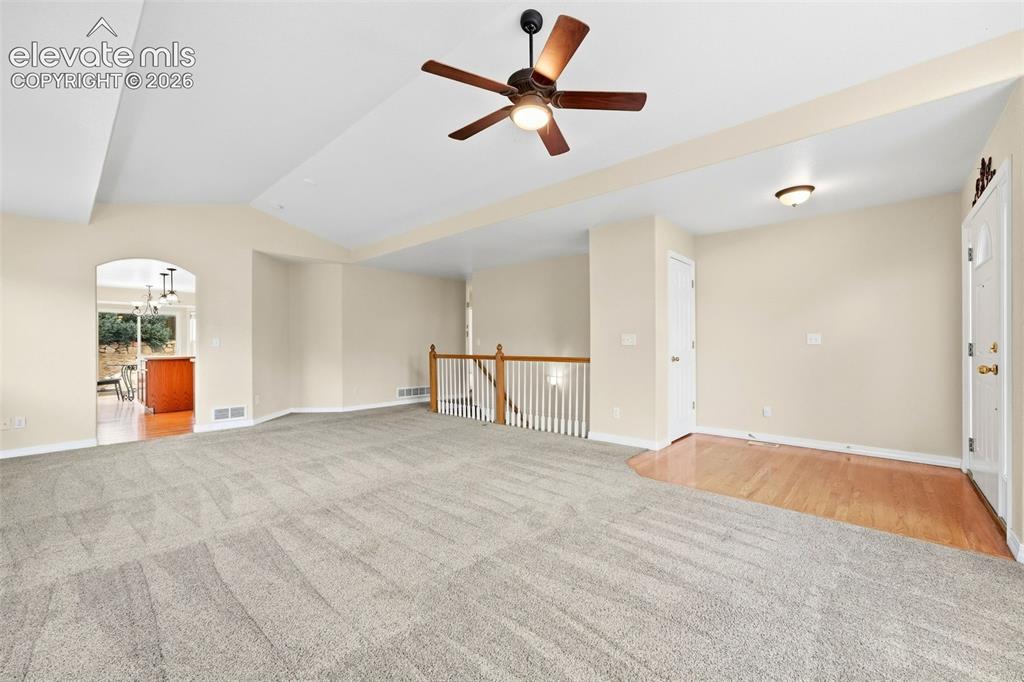 Image 5 of 47: Living Room featuring Soaring Vaulted Ceilings