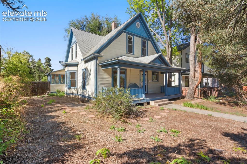 Image 1 of 31: Front of home featuring the covered front porch and side sunroom.