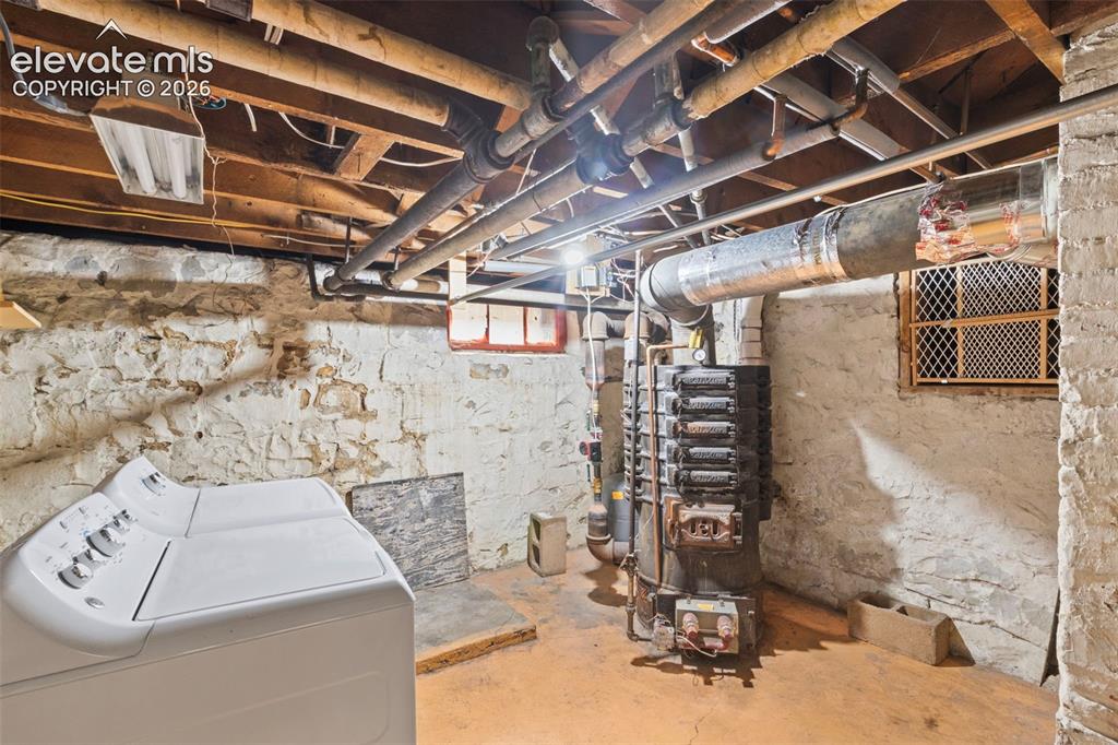 Image 27 of 31: Basement with laundry equipment and boiler system
