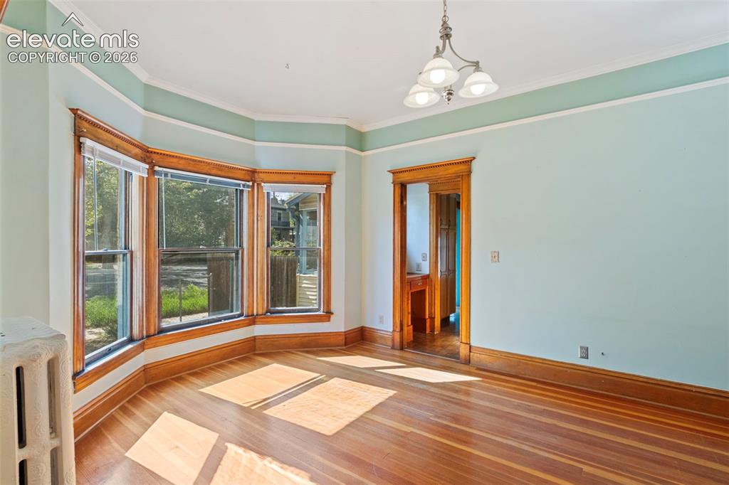 Image 8 of 31: Dining room with bay windows and beautiful wood work
