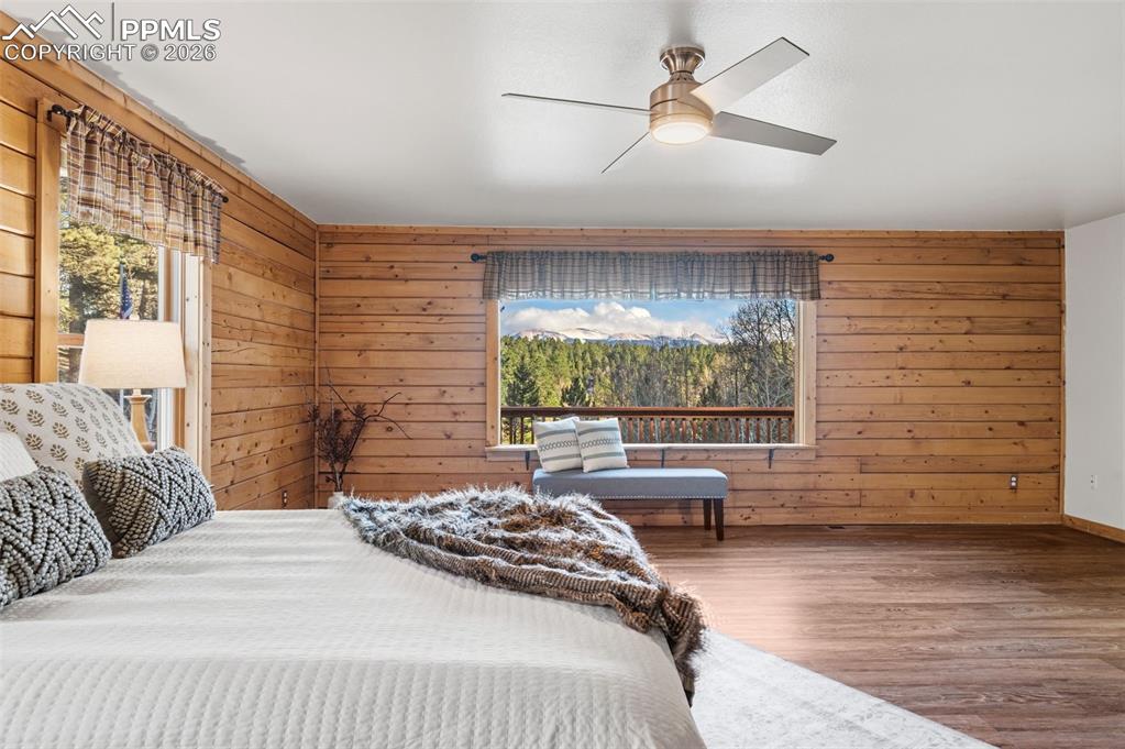 Image 14 of 41: Main level primary bedroom with large picture windows