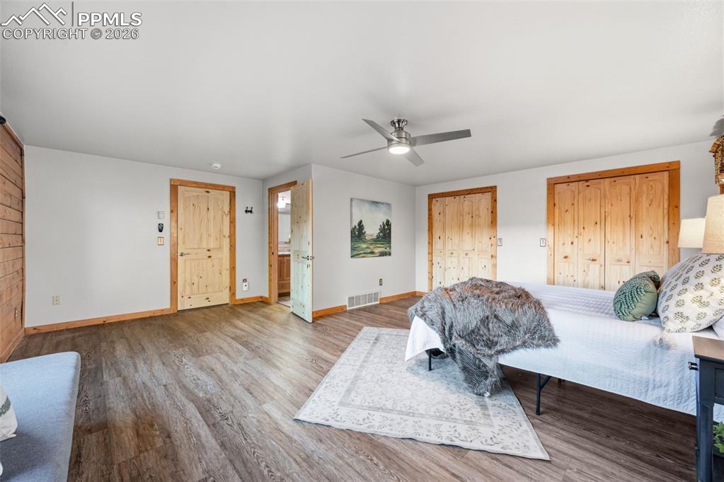 Image 15 of 41: Main level primary bedroom with large picture windows