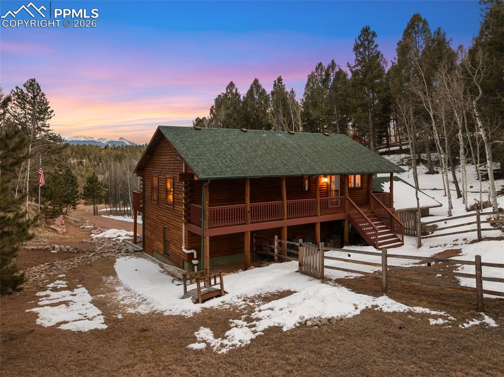 Image 3 of 41: Back of home with covered deck 