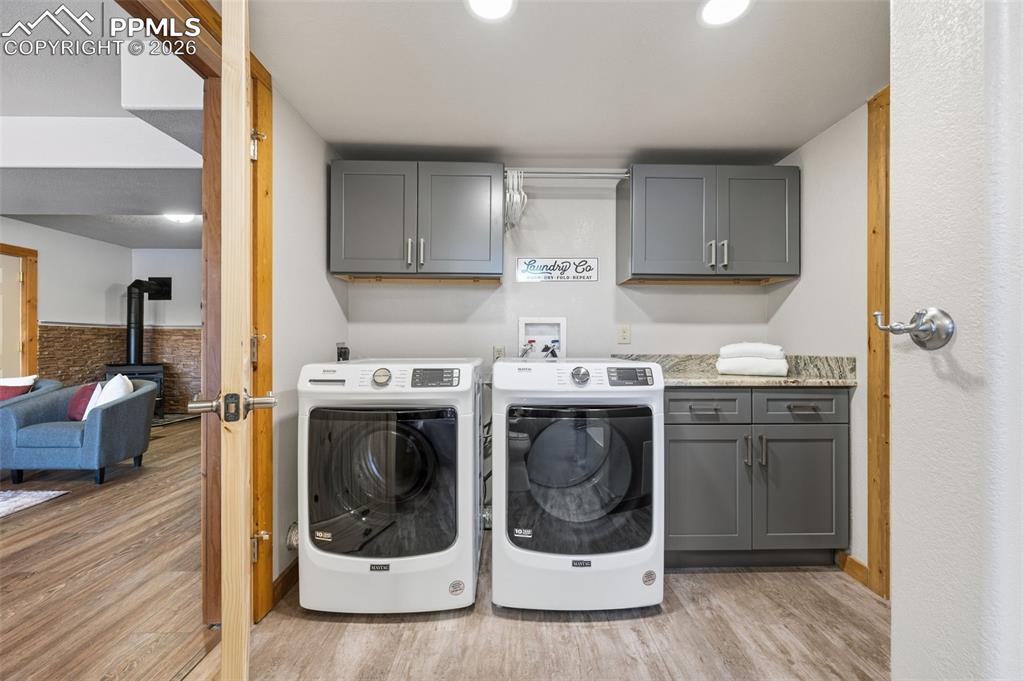 Image 30 of 41: Basement level laundry in bathroom
