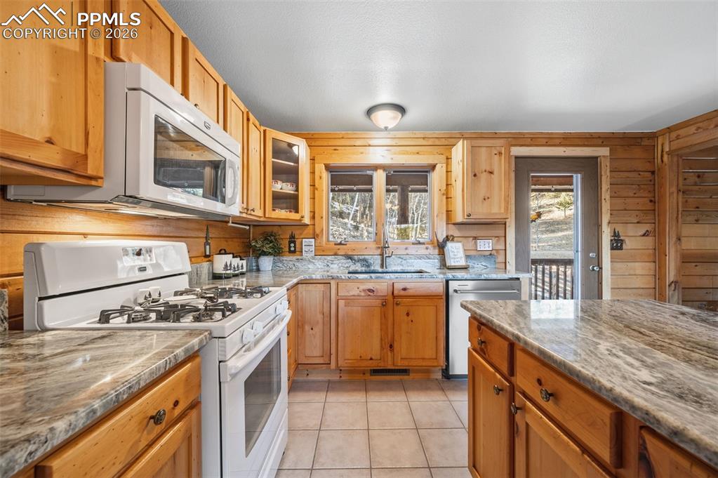 Image 8 of 41: Main level kitchen with upgraded granite countertops