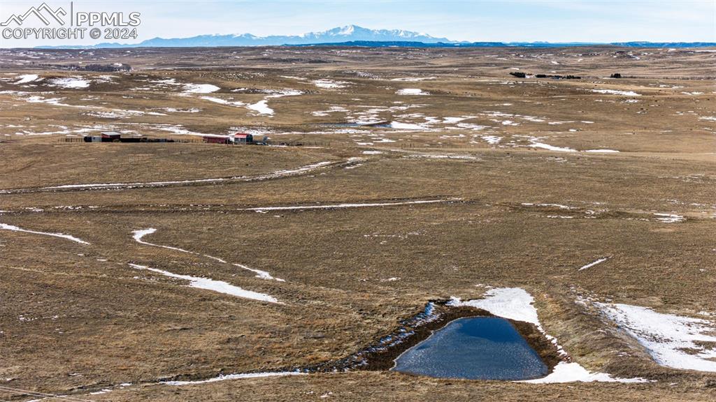 Image 2 of 20: Drone / aerial view of pond and Pikes Peak.