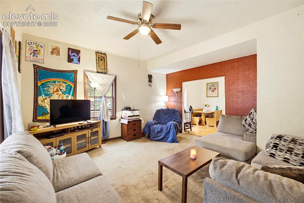 Image 12 of 26: Recessed entryway leading to an interior space with a ceiling fan, carpeted