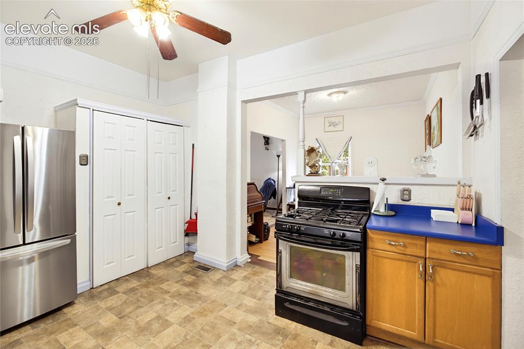 Image 19 of 26: Kitchen featuring a gas range, wood-finish flooring, wood cabinetry, and a 