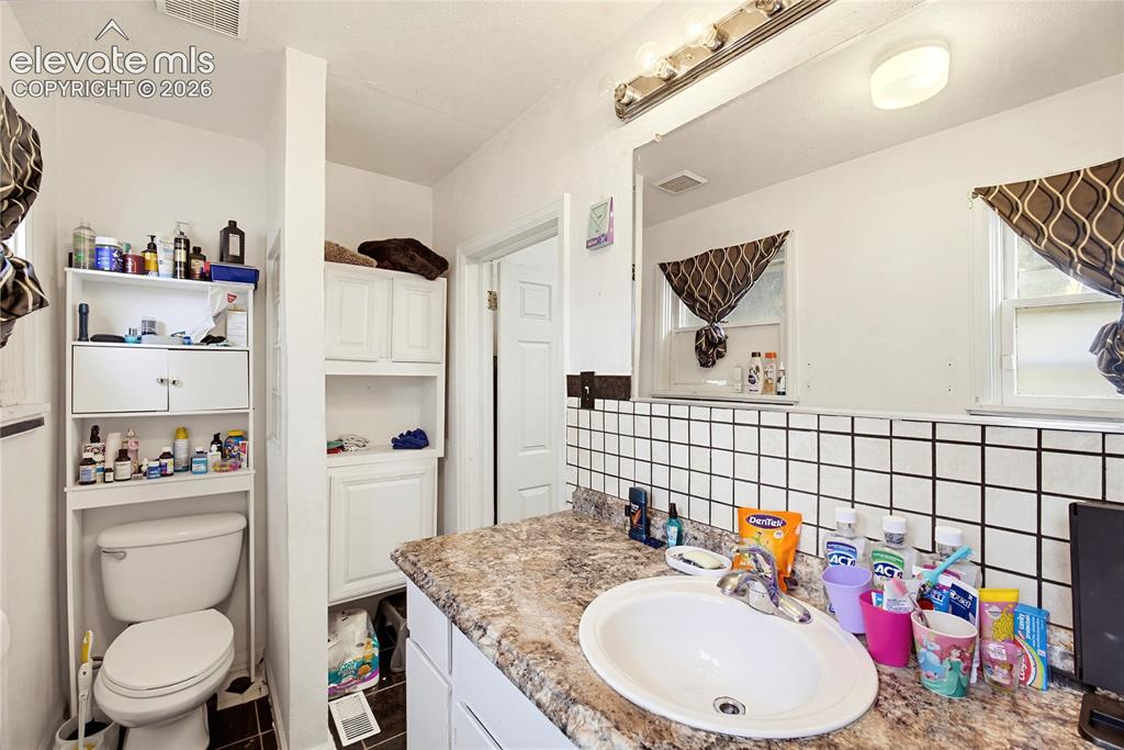 Image 21 of 26: White tile backsplash with black grout
