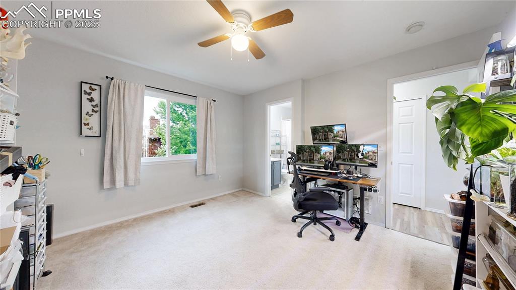 Image 13 of 37: Office space featuring ceiling fan and carpet floors