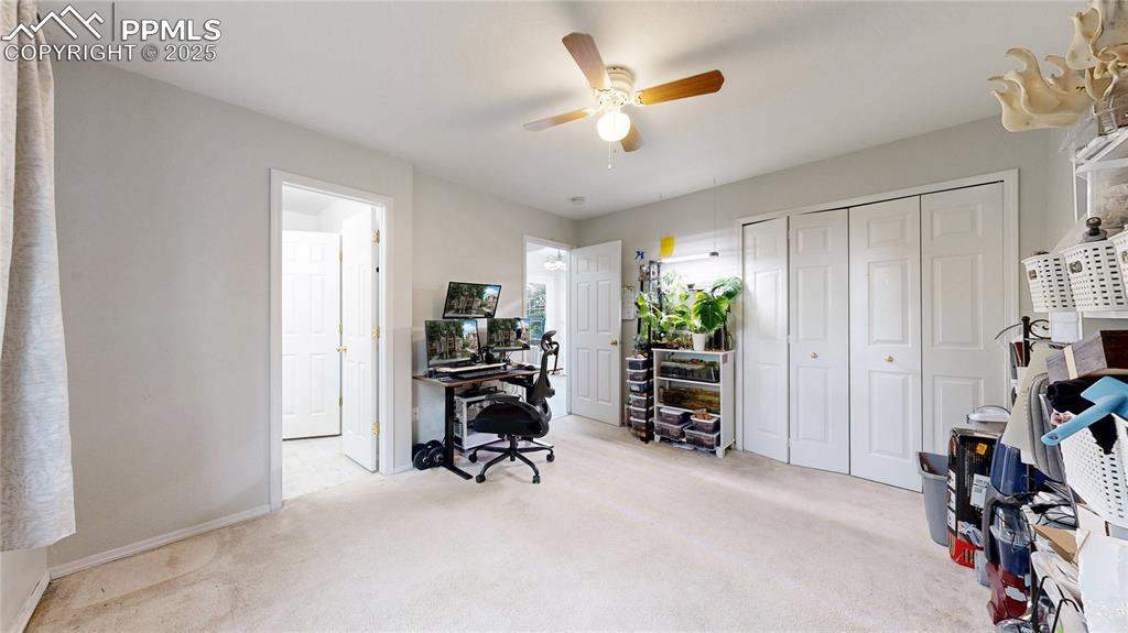 Image 14 of 37: Carpeted office space with a ceiling fan and baseboards