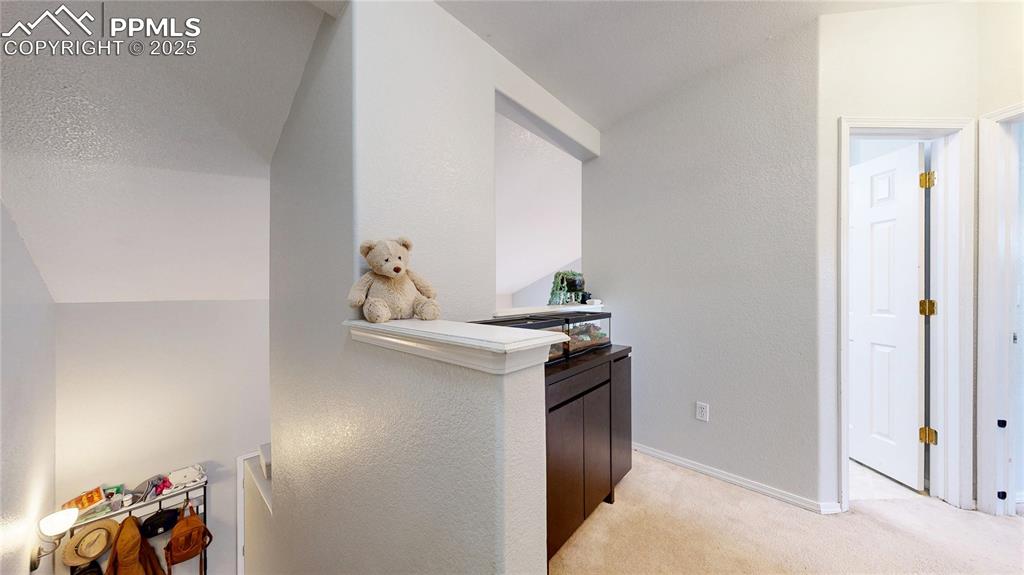 Image 17 of 37: Hall featuring light carpet and lofted ceiling