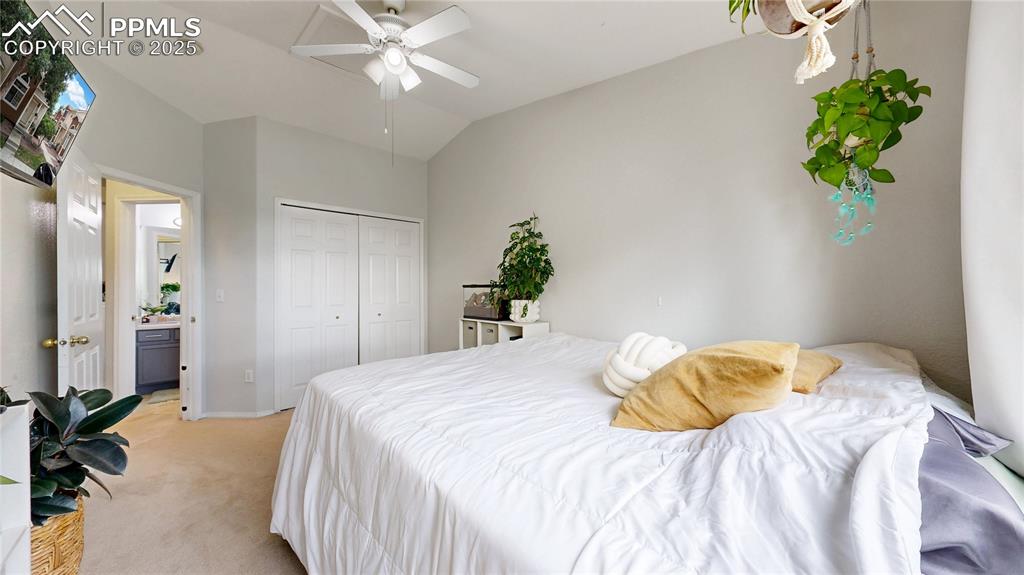 Image 24 of 37: Bedroom featuring light colored carpet, a closet, lofted ceiling, and ceili