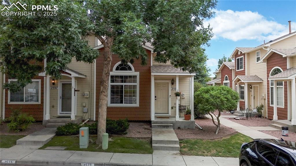 Image 30 of 37: Townhome / multi-family property with a shingled roof