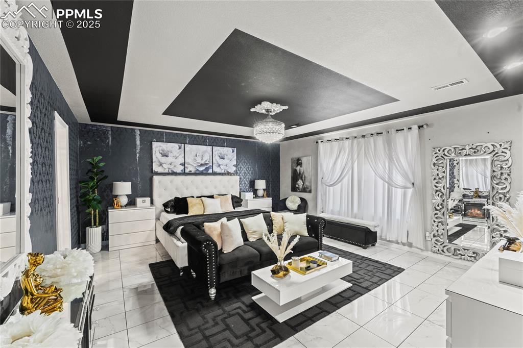 Image 22 of 39: Bedroom featuring a tray ceiling
