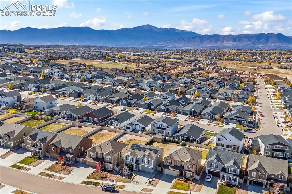 Image 35 of 39: Aerial perspective of suburban area with a mountain backdrop