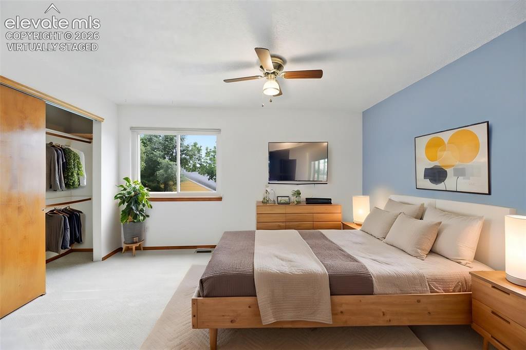 Image 24 of 50: Virtually Staged - Bedroom featuring a light blue accent wall and neutral c