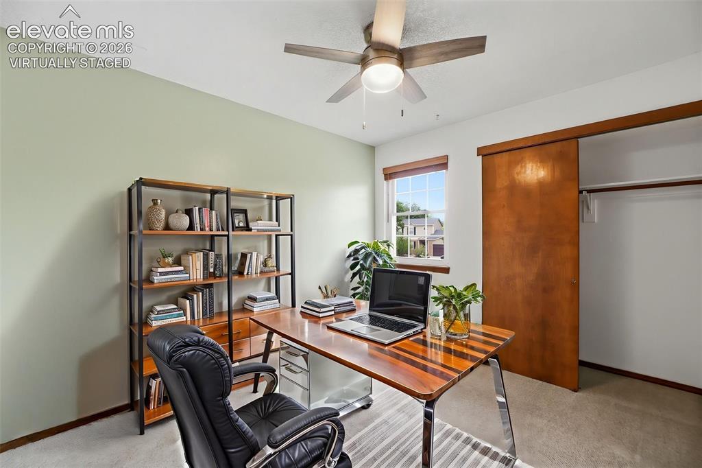 Image 29 of 50: Virtually Staged - carpeted room with a ceiling fan light fixture, a window