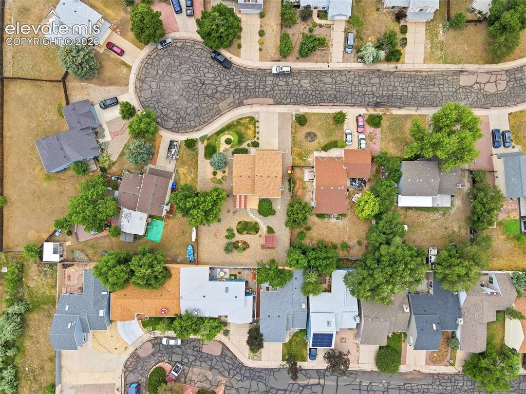 Image 46 of 50: Residential neighborhood featuring a cul-de-sac with patterned asphalt