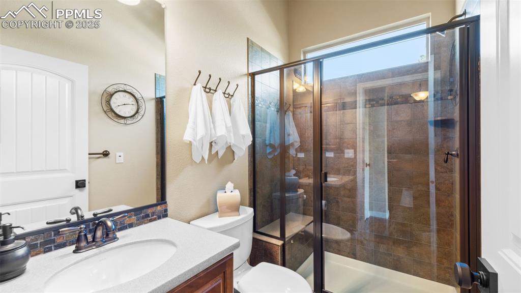 Image 10 of 48: Bathroom with glass shower that doubles as your new karaoke stage.
