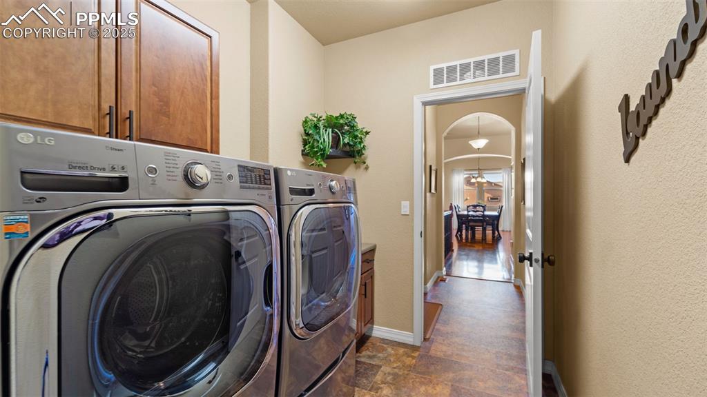 Image 22 of 48: Laundry room so sleek it might actually convince you to enjoy laundry day.