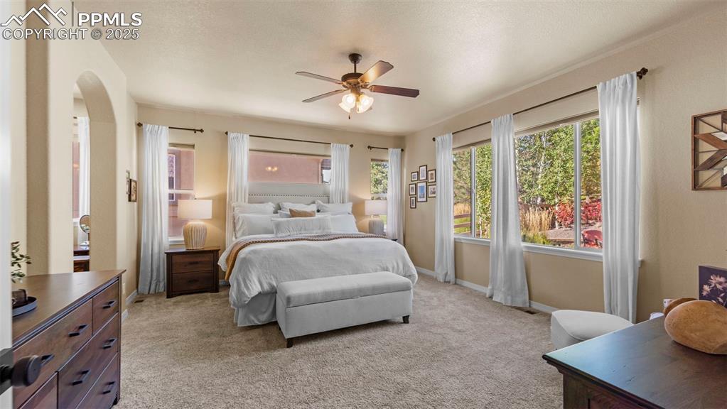 Image 25 of 48: Bright and roomy with space for a king bed and that "reading chair" that se