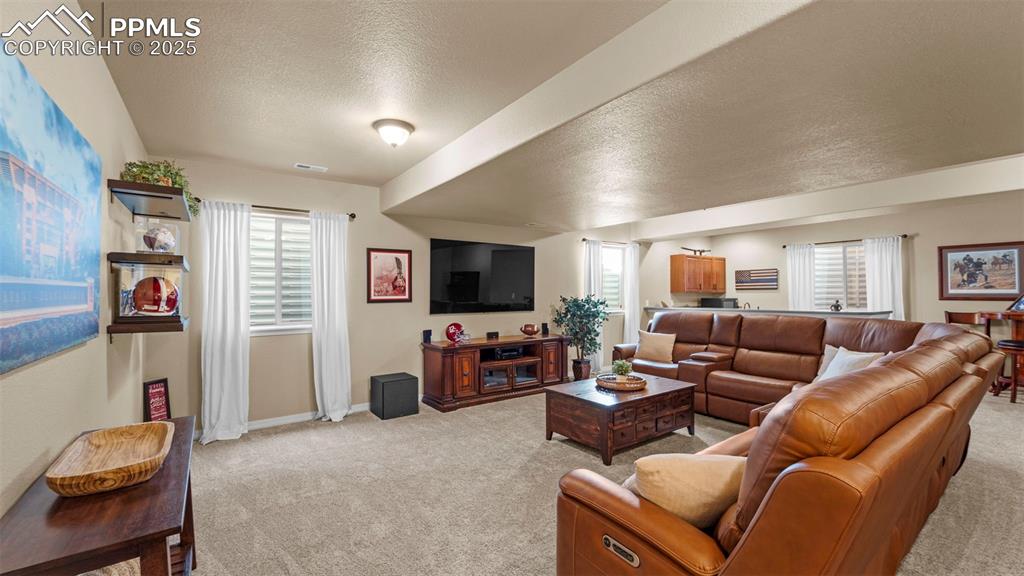 Image 27 of 48: Second living room for game nights, movie marathons, or friendly debates ab