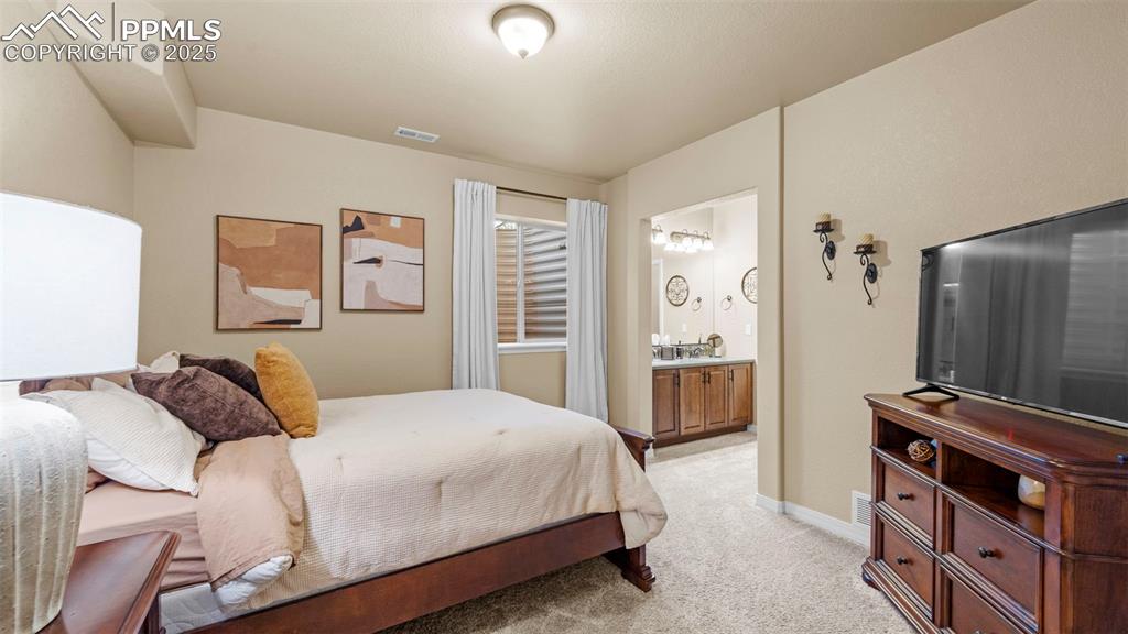 Image 32 of 48: Bedroom where the walls practically beg you to hang fairy lights or art pri