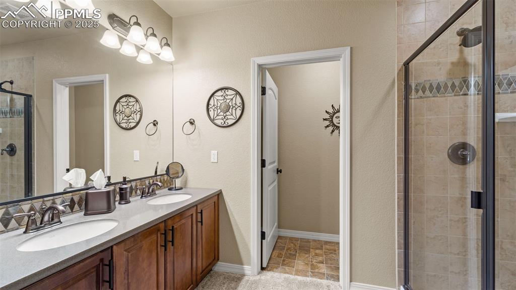 Image 34 of 48: Bathroom with dual sinks so no one has to fight over mirror time again.