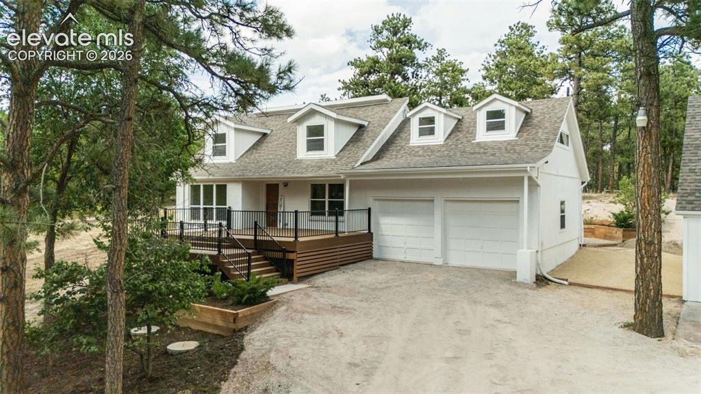 Image 1 of 43: Cape cod-style house featuring an attached garage, driveway, a shingled roo