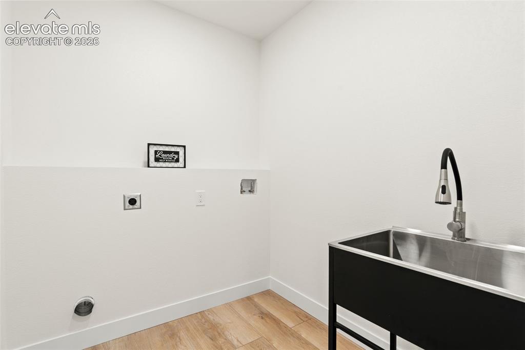 Image 18 of 43: Laundry room with light wood finished floors, washer hookup, and electric d